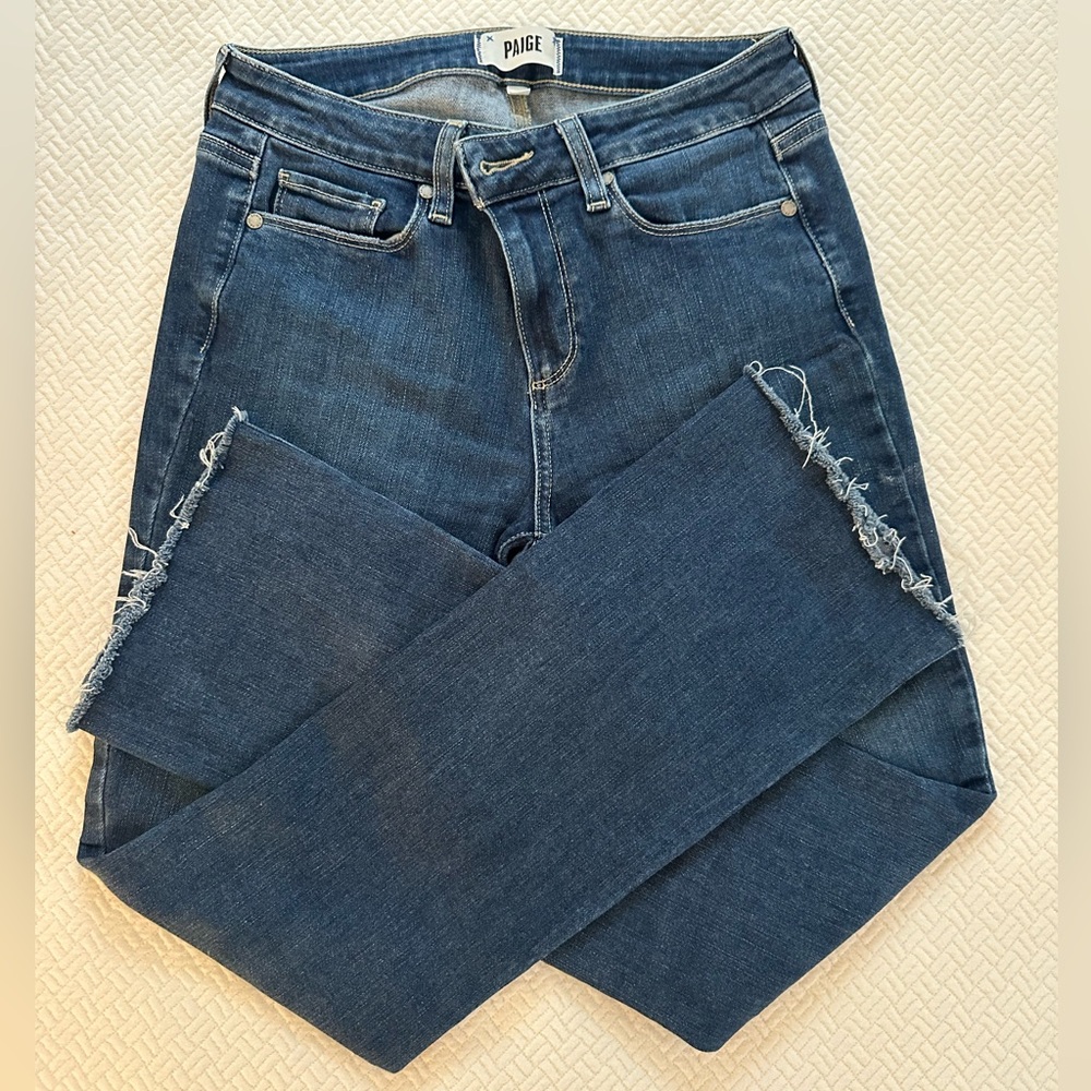 PAIGE Women's Distressed frayed boot cut Jeans in Dark Blue.
